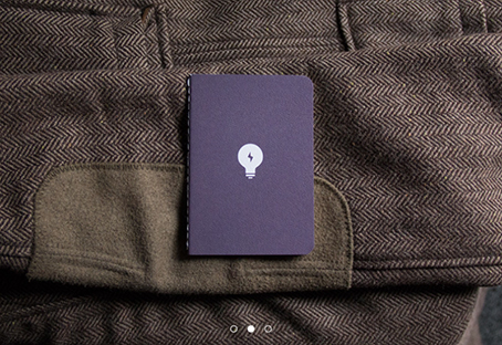 "Limited edition" pocket notebook with a lightbulb on the cover, handsomely presented against a tweed jacket